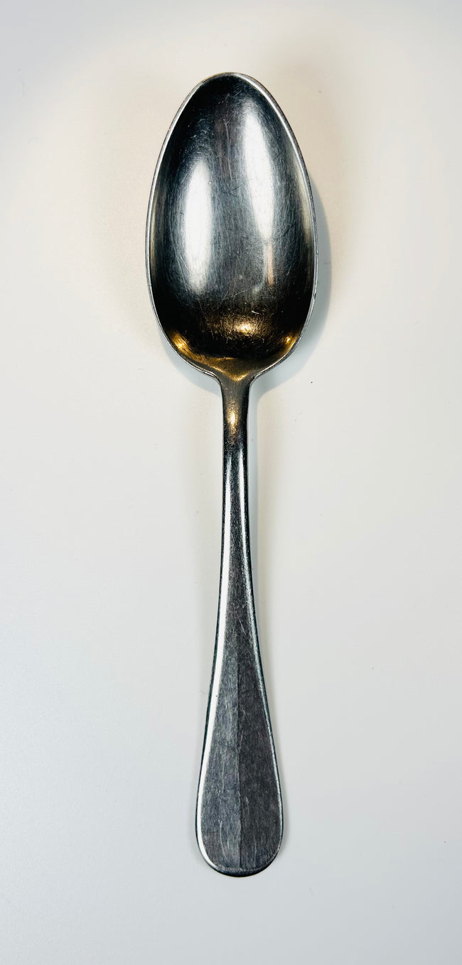 WWII German naval spoon with polished bowl and worn handle showing age and use