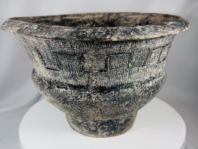 Thai Ban Chiang-inspired pottery vessel featuring textured surface patterns and sculptural form