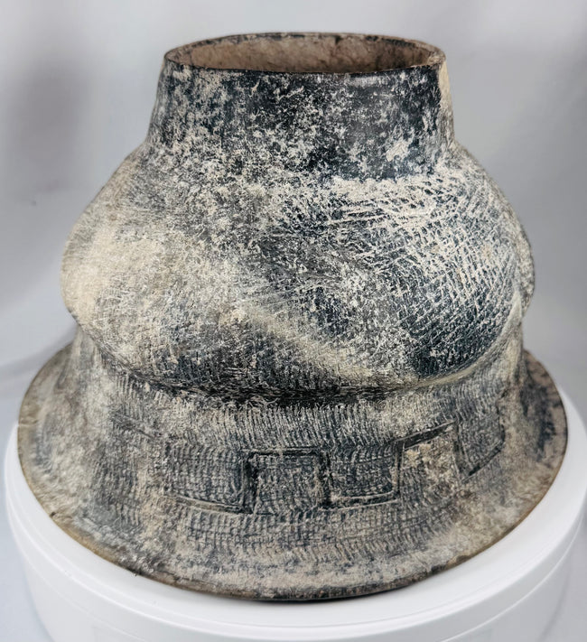 Large Southeast Asian pottery vessel with incised designs and weathered mineral-like finish