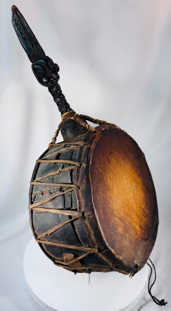 Himalayan shaman's drum from Nepal displaying extensive rawhide bindings and traditional ceremonial craftsmanship.