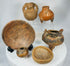Curated collection of six Pre-Columbian pottery pieces including bowls, effigy vessels, and tripod forms