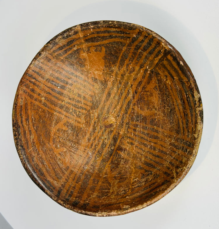 Pre-Columbian painted ceramic bowl with geometric designs and worn surface decoration