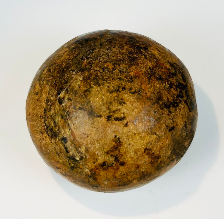 Ancient rounded ceramic container used for storage or ritual offerings with aged surface