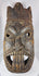 Traditional African ceremonial mask with elongated nose, projecting tongue motif, and carved headdress.