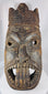 Traditional African ceremonial mask with elongated nose, projecting tongue motif, and carved headdress.