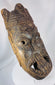 Antique tribal mask from West Africa with stylized facial features and deeply hollowed hand-carved interior.