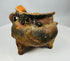 Pre-Columbian tripod vessel with burnished orange surface and three short legs