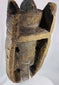 Carved hardwood African mask with powerful expression, worn patina, and ethnographic character.