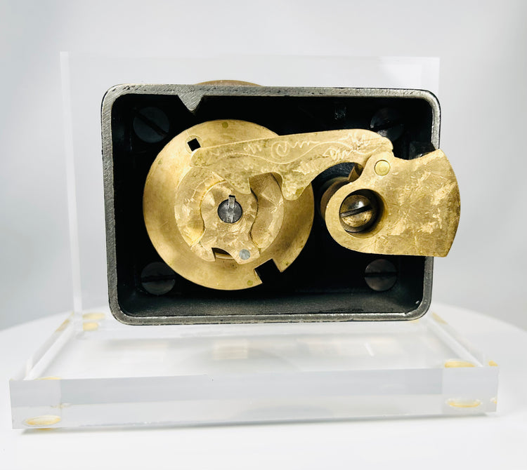 Antique brass dial safe lock front showing engraved numbers and maker mark