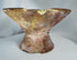 Ancient terracotta offering vessel displaying red and cream painted decoration and historic restorations.