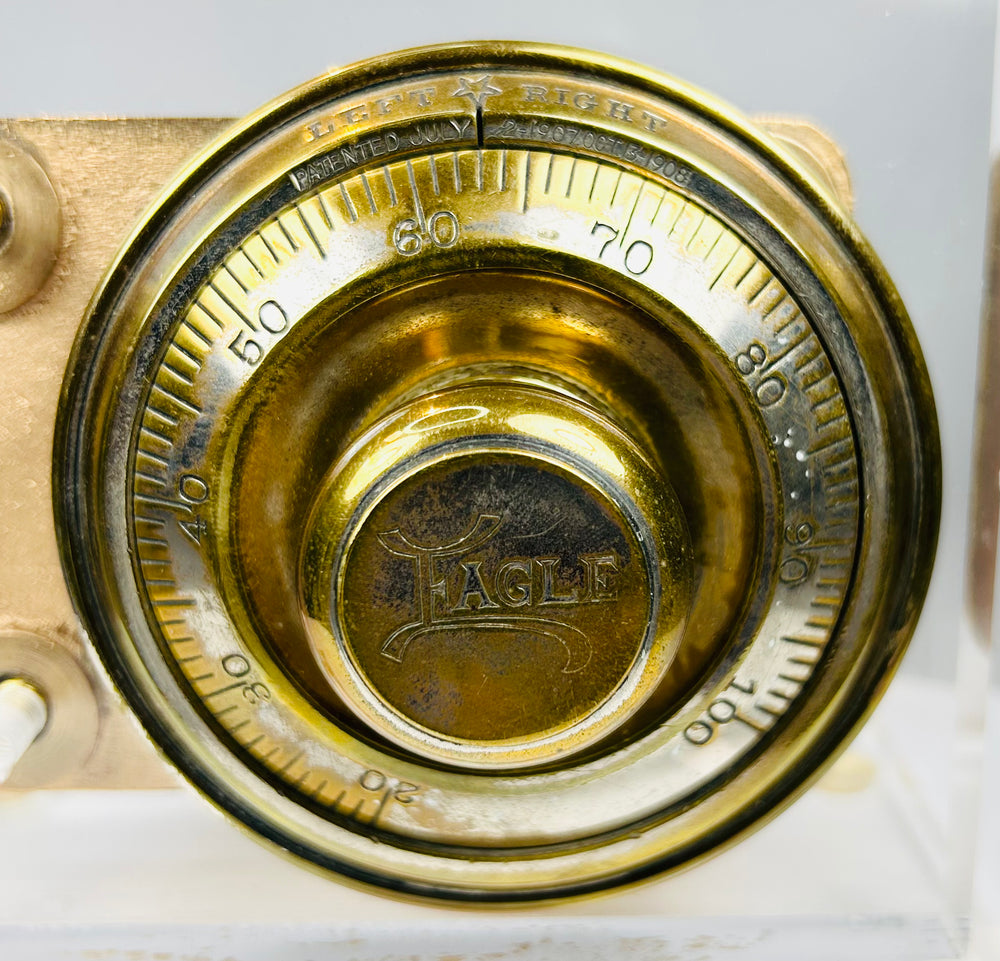 Vintage safe lock mechanism showing internal components and brass dial
