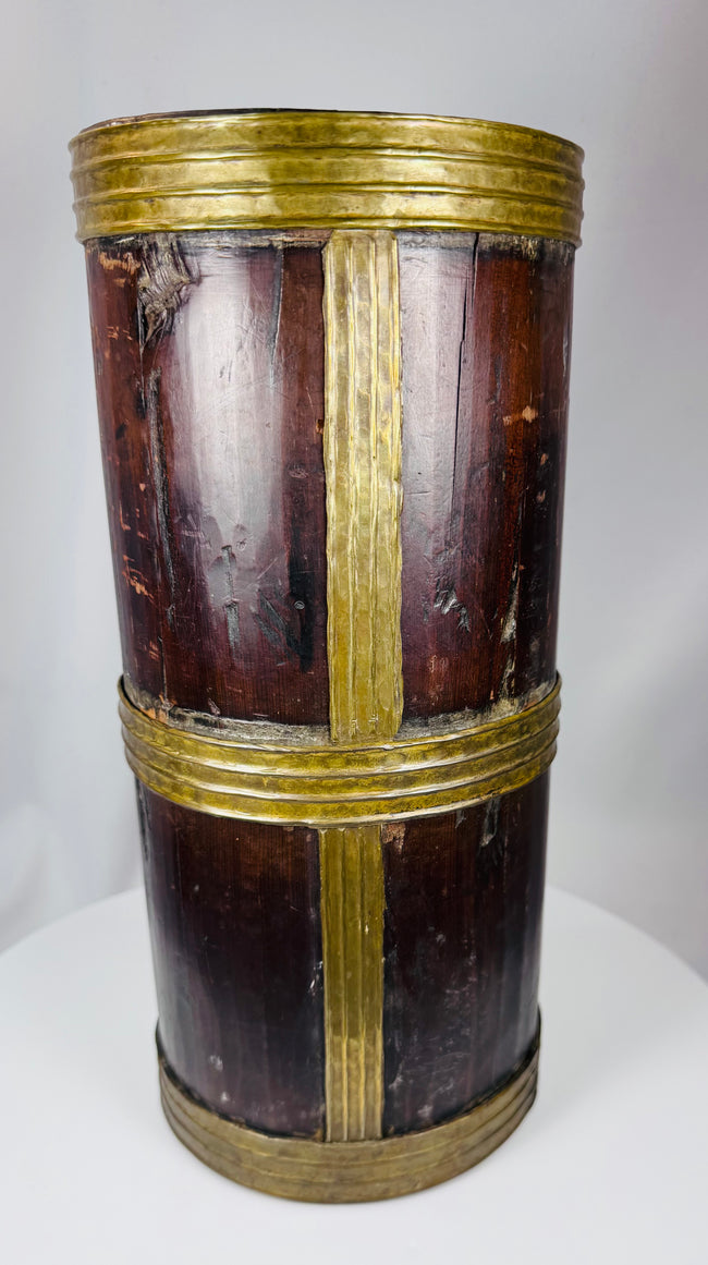 Himalayan hardwood storage jar displaying rich patina, hand-crafted brass fittings, and age-related wear.