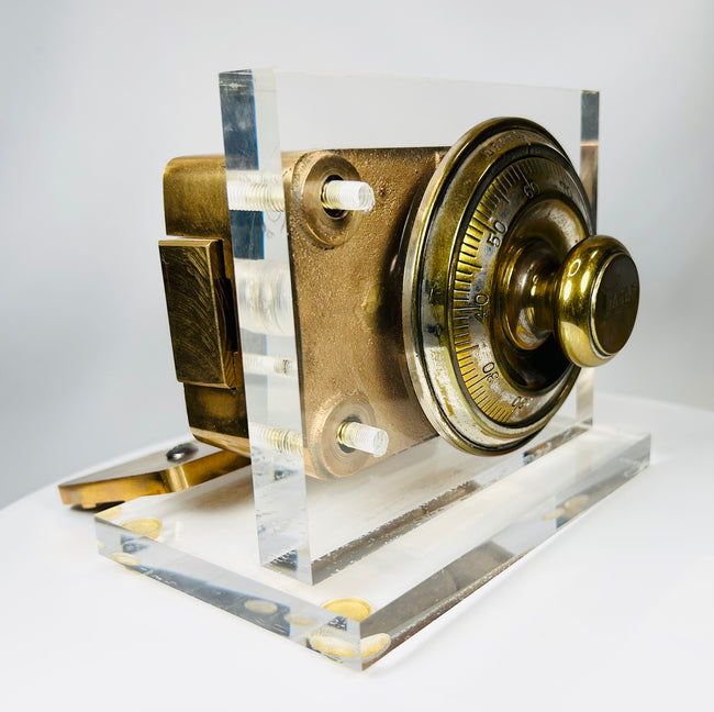 Antique vault lock mechanism with rotating dial and cast metal housing