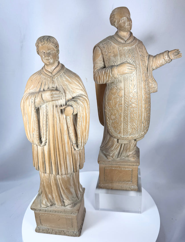 Pair of ecclesiastical wooden sculptures likely representing saints or clergy from 18th–19th century Europe.