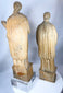 Hand-carved Christian figures with intricate robe decoration and centuries of aged character.