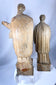 Hand-carved Christian saint figures in wood featuring detailed vestments and expressive facial features.