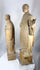 Antique wooden religious statues featuring a bearded cleric and youthful saint holding a symbolic attribute.