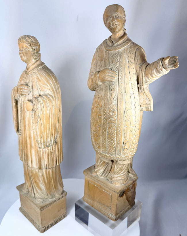 European devotional wooden figures displaying hand-carved drapery folds and ecclesiastical attire.