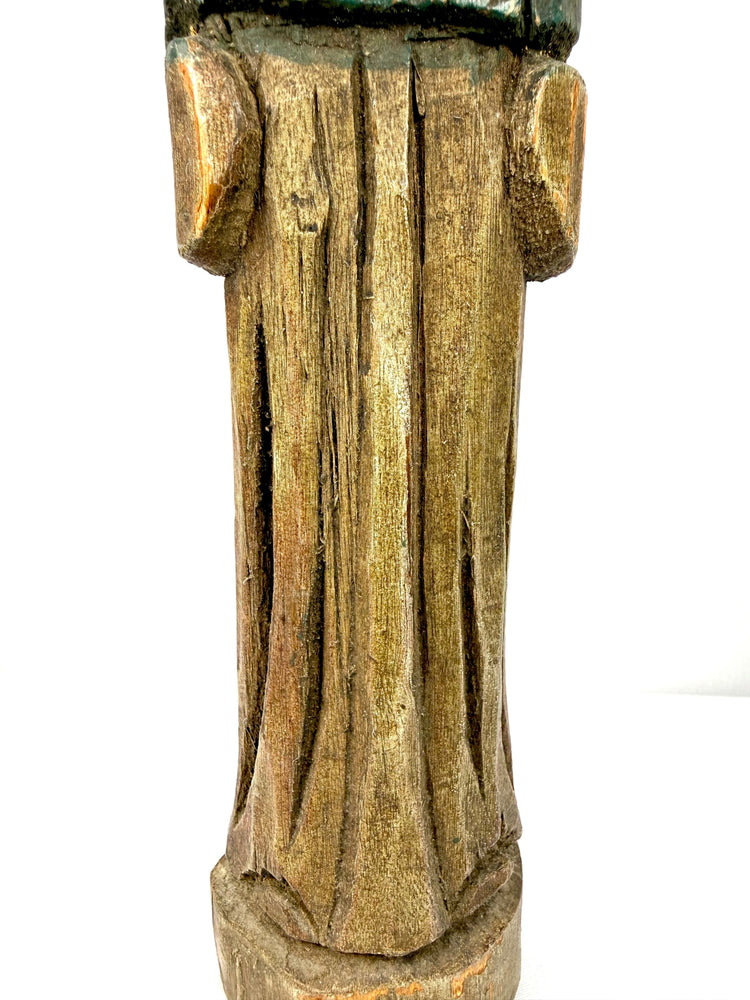 Detail of lower section showing deep vertical grooves and aged wood grain on antique statue