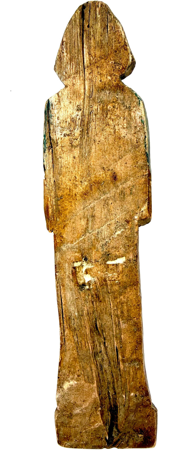 Antique hand-carved wooden figurine back view with green pigment traces and wood grain