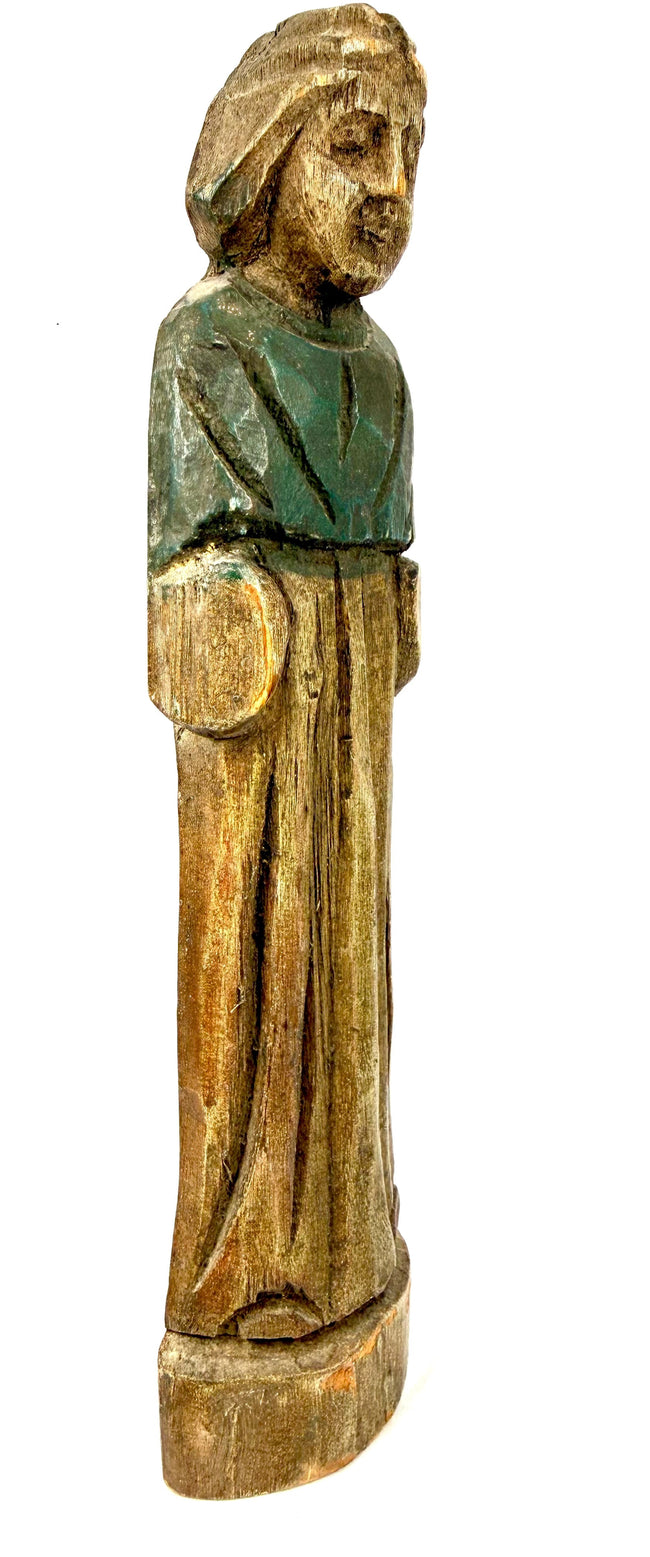 Early European religious wooden carving with faded green pigment on the upper garment and centuries of natural surface wear.