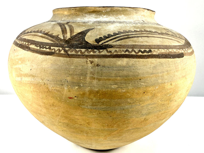 Early 20th-century Mexican terracotta olla with a rounded body, gently flared neck, and traditional dark pigment decoration.