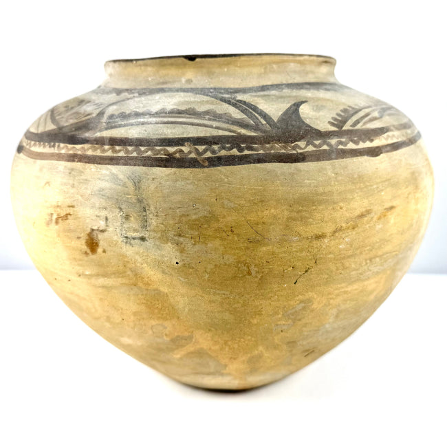 Frontal view of hand-molded terracotta jar with dark pigment art
