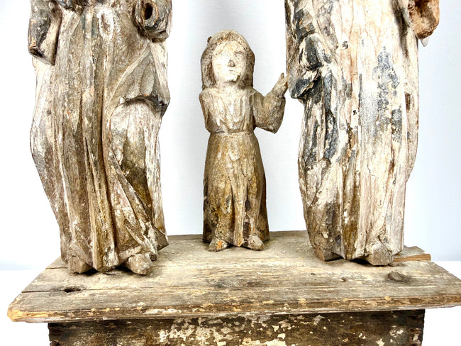 Lower section of Holy Family group showing carved robe drapery folds and child's feet
