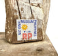 Close-up of National Museum Philippines authenticity sticker on rough antique wood surface