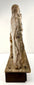 Side profile of antique carved wood Holy Family group highlighting vertical grain texture and plinth