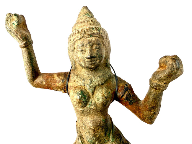 Antique Hindu or Buddhist bronze sculpture representing a dancing Devata or Apsara with intricate ceremonial adornments.