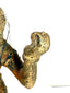 Macro detail of pitted bronze hand and wrist with mounting wires