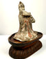 Side profile aged terracotta figurine musician on carved wooden stand