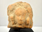 Direct close-up of Gandharan terracotta fragment emphasizing central bust relief