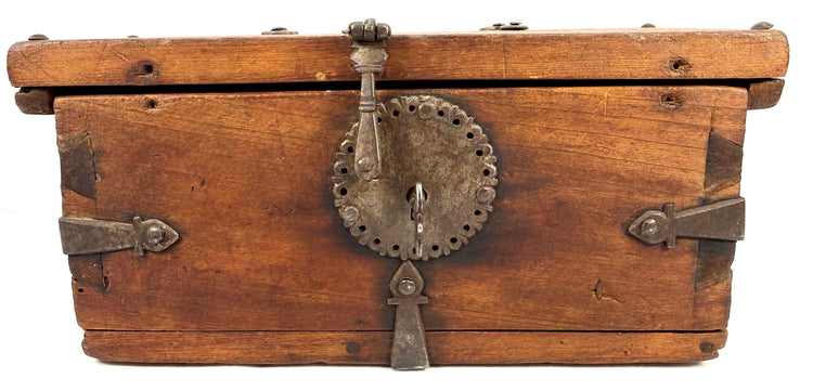 Frontal view of elmwood lockbox with heavy dark iron hardware, strap hinges, and central locking mechanism