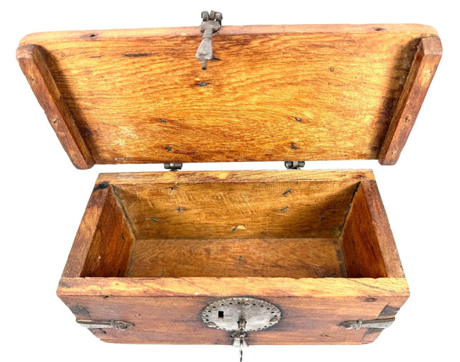 Historic Himalayan lockbox featuring a solid elmwood body, sturdy iron hinges, and decorative metal strapping.