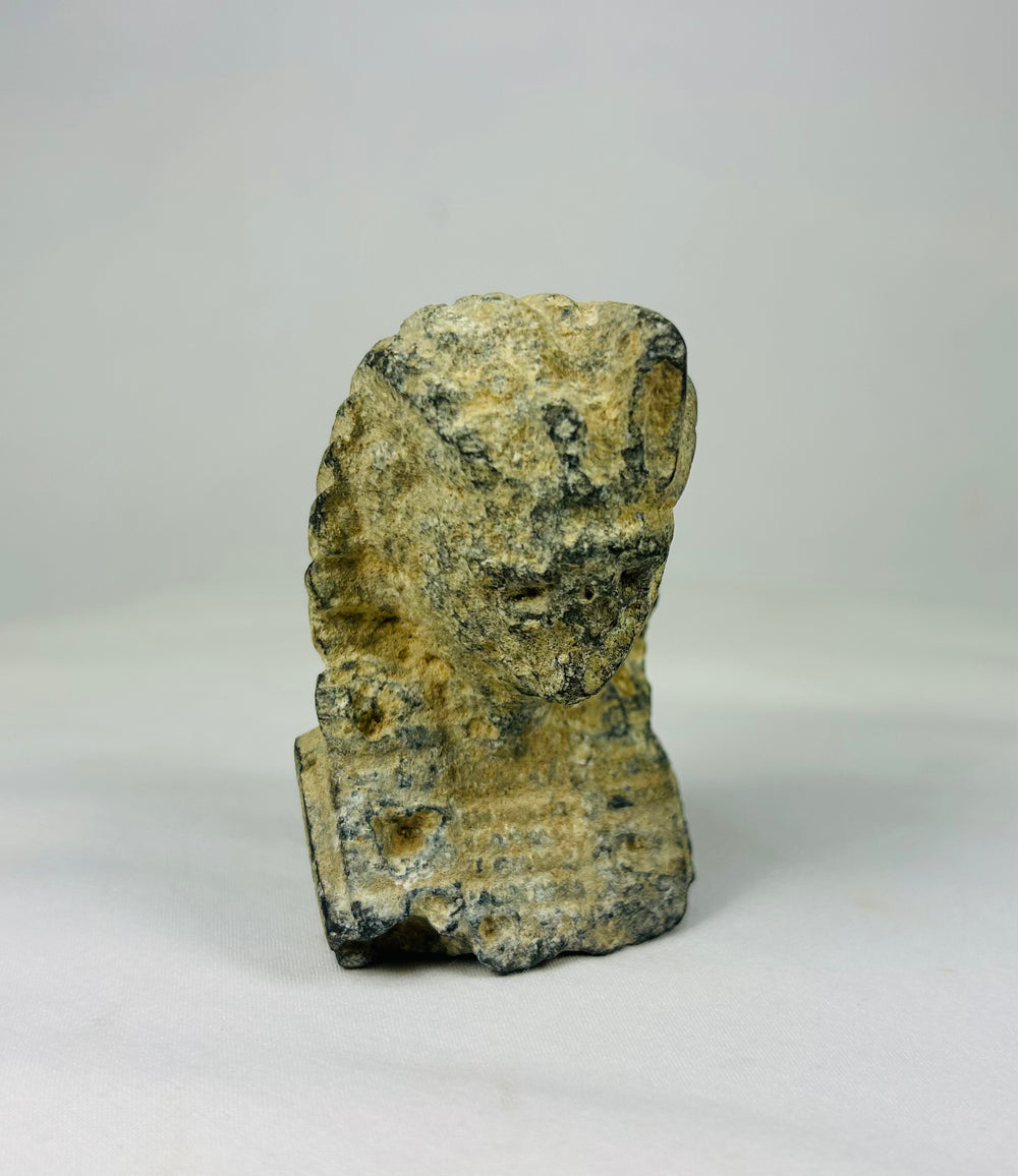 Antique carved limestone head of a pharaoh wearing a nemes headdress with uraeus, European Grand Tour piece circa 1800–1920 on a neutral backdrop.