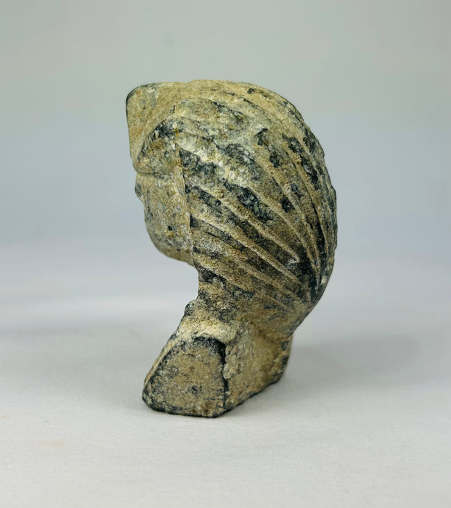 European Grand Tour reproduction of an Egyptian pharaoh’s head in carved limestone with nemes and uraeus, circa 19th–20th century, on a soft neutral backdrop.