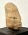 Three-quarter angle of Mesoamerican terracotta head showcasing protruding lips and extended skull length