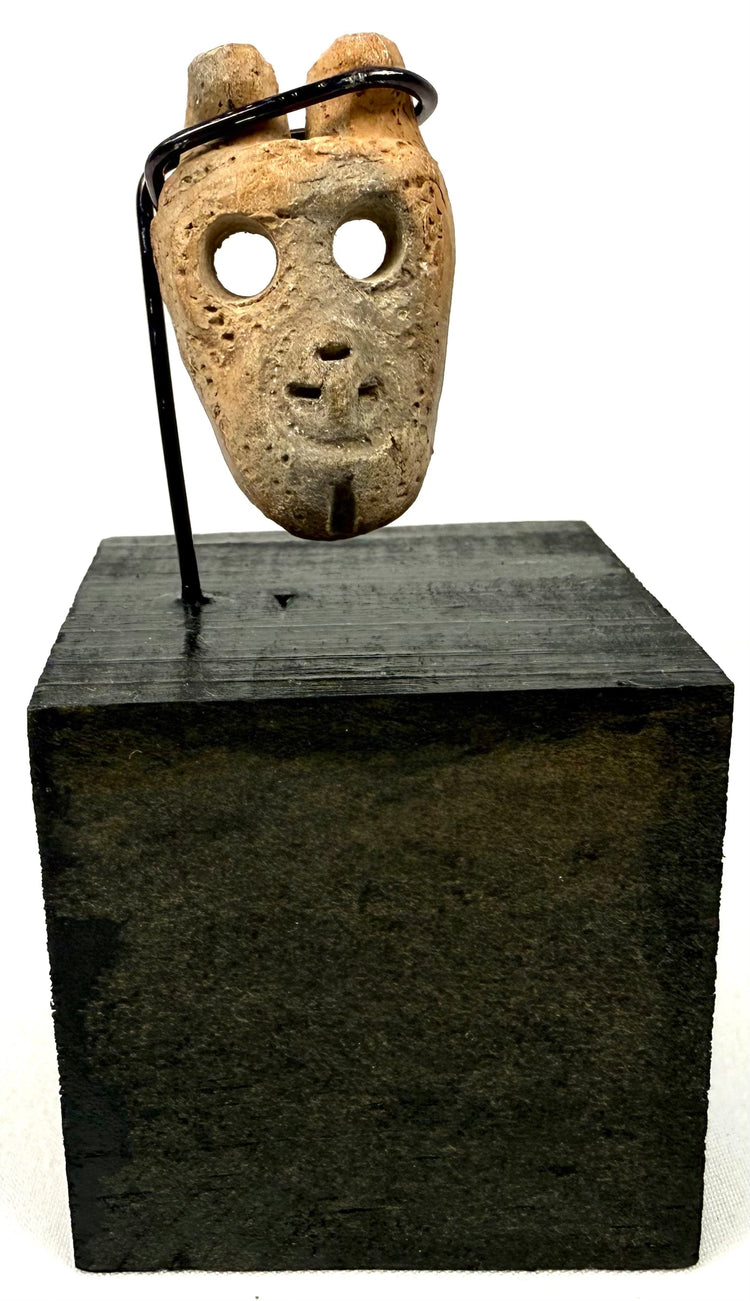 Ancient West Mexican carved bone mask pendant, circa 300 BCE–300 CE, featuring hollowed eyes, prominent nose, and open mouth.