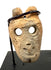 Frontal view of beige carved bone miniature anthropomorphic mask pendant with hollow eyes