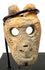 Ancient Mesoamerican anthropomorphic bone pendant featuring a stylized human face, recessed eyes, and twin suspension holes.