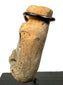 Side profile of weathered beige bone artifact highlighting thickness and surface texture