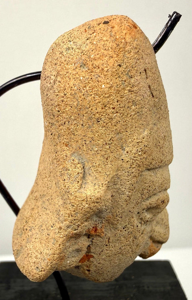 Right profile of terracotta head sculpture showing ear detail and angular nose structure