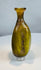 Authentic Roman Imperial glass flask featuring an olive green body and decorative vertical fluting
