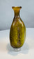 Authentic Roman Imperial glass flask featuring an olive green body and decorative vertical fluting