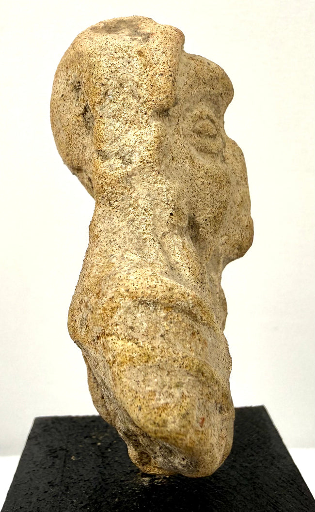 Archaeological fired-clay human figure fragment with an unfinished reverse, surface weathering, and losses to the lower body.
