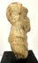 Archaeological fired-clay human figure fragment with an unfinished reverse, surface weathering, and losses to the lower body.