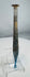 Ancient Roman pale blue glass candlestick unguentarium displaying archaeological weathering and iridescence