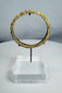 Ancient Roman blue-green glass bracelet with applied decorative protrusions and iridescent weathering.